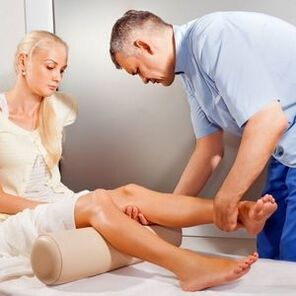 A doctor examines a patient's knee joint